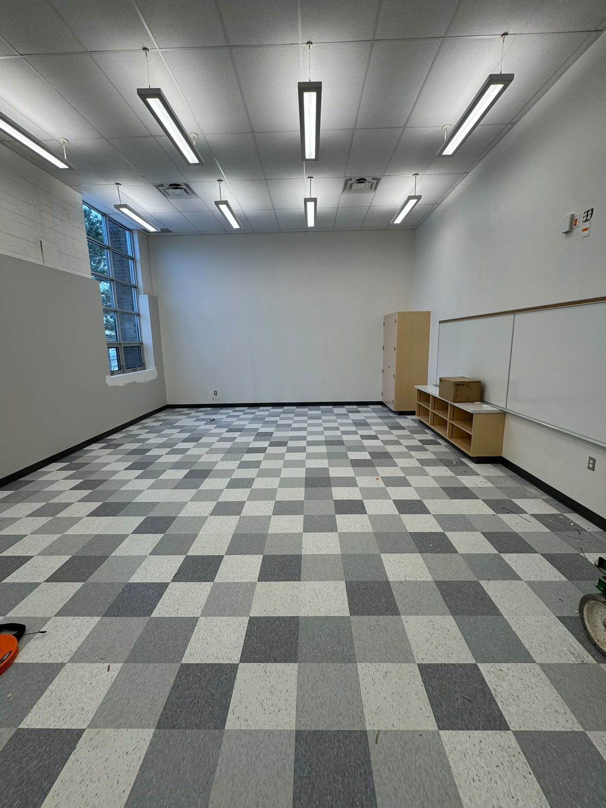 Same classroom after installation of grey checkered VCT tile flooring