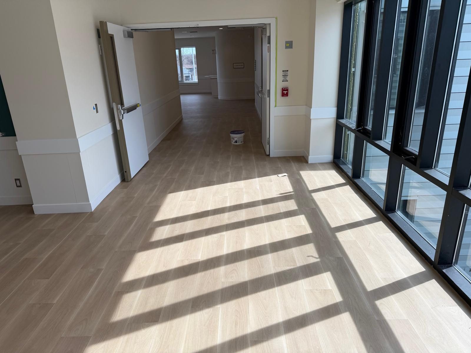 Corridor after wide-plank luxury vinyl flooring installation