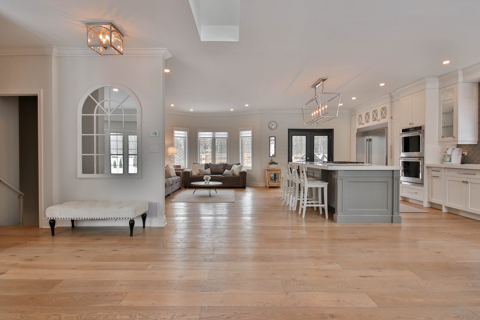 Wide-plank engineered hardwood flowing through an open-concept kitchen and living space